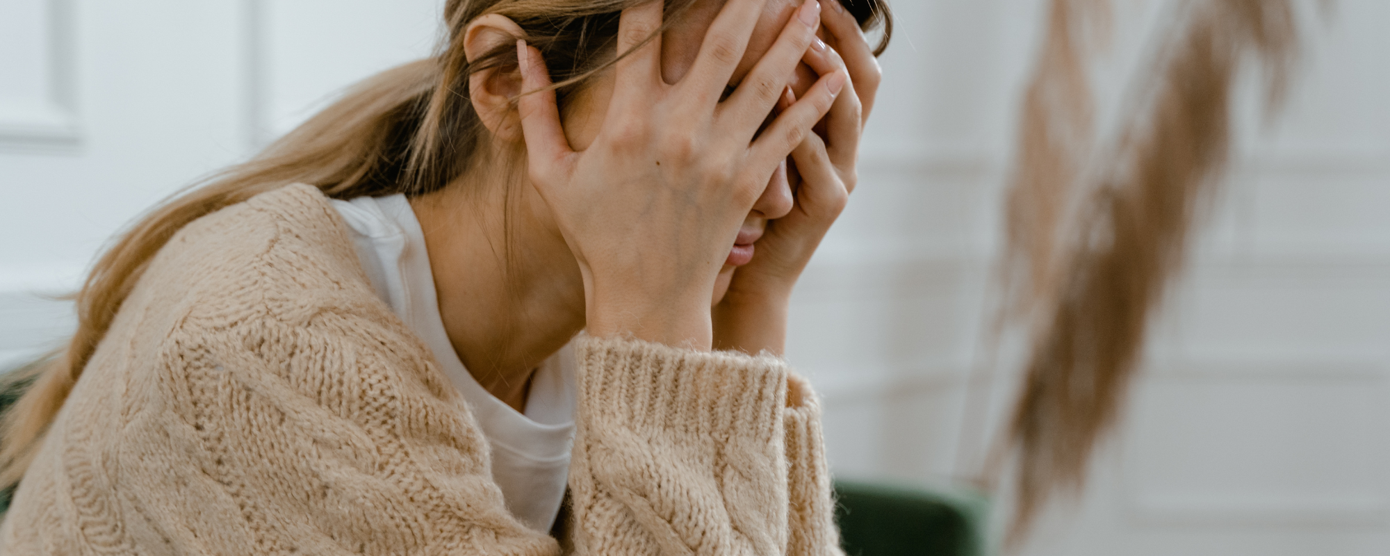 sad woman with her head in her hands